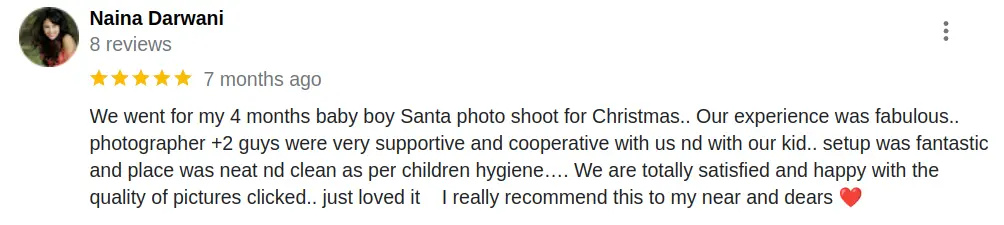 Happy review from Naina Darwani, praising the Christmas baby photoshoot in Ahmedabad for cleanliness and supportive staff.